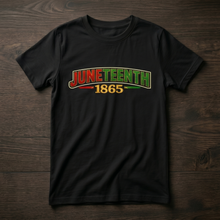 Black youth t-shirt flat lay featuring a vibrant Juneteenth 1865 futuristic logo in red, gold, and green. This Juneteenth shirt for boys and girls showcases a bold graphic design on a high-quality cotton tee, perfect for Juneteenth celebrations, Black history events, and African American pride outfits for kids.