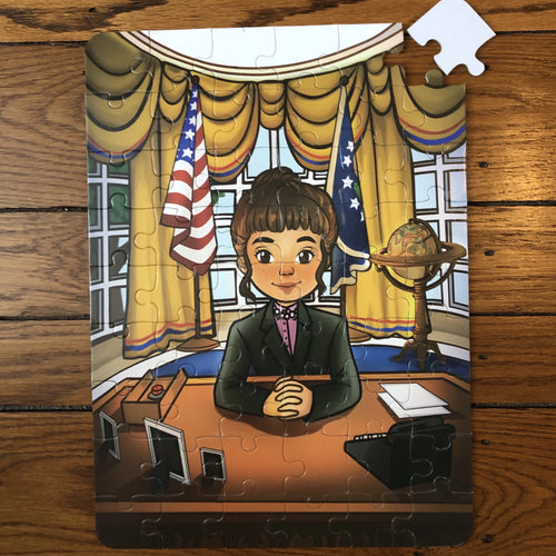 A completed jigsaw puzzle depicting a cartoon image of a girl sitting at a desk in the Oval Office, with American flags in the background. The puzzle is assembled from numerous pieces, placed on a wooden surface.